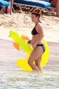 Coleen Rooney, wife of footballer Wayne Rooney, shows off her baby bump in a bikini as she plays with son Kai on the beach in Barbados