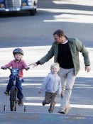 Liev Schreiber and little Samuel cheer on Alexander as he tests out his training wheels in Los Angeles
