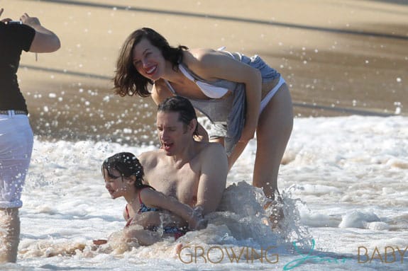 Milla Jovovich spotted on the beach in a bikini on New Years Eve in Maui, Hawaii.