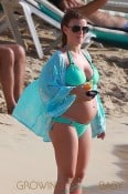 A pregnant Coleen Rooney, wife of Manchester United star Wayne Rooney, takes her son Kai out for some fun in the sun and sand in Barbados