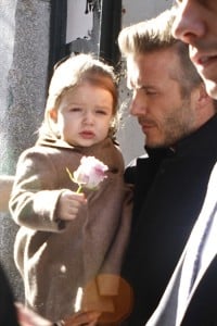 David Beckham holds onto his daughter Harper as they head to a waiting car after watching Victoria Beckham's Fall 2013 fashion show