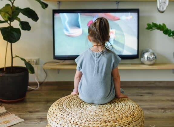 little girl watching television