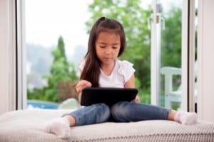 child with an iPad