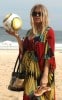 Fergie, wearing a bright, draping dress, visits Ipanema beach with her entourage in Rio De Janerio