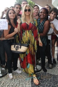 Fergie plays sweet to her fans as she tosses them treats from the balcony of the Fasano hotel in Rio De Janerio