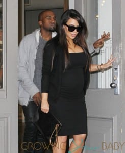 Kim Kardashian shows off a growing baby bump in a black dress as she reunites with baby daddy Kanye West in NYC