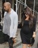 Kim Kardashian shows off a growing baby bump in a black dress as she reunites with baby daddy Kanye West in NYC