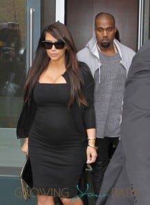 Kim Kardashian shows off a growing baby bump in a black dress as she reunites with baby daddy Kanye West in NYC