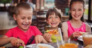 kids enjoying dinner at restaurant