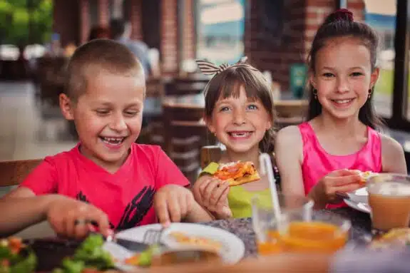 kids enjoying dinner at restaurant