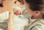 new mom holding her baby in the hospital