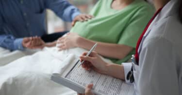 pregnant woman in the hospital getting checked out by doctors