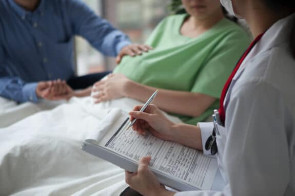 pregnant woman in the hospital getting checked out by doctors