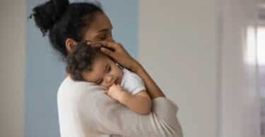 oving african American mom hug embrace small baby child