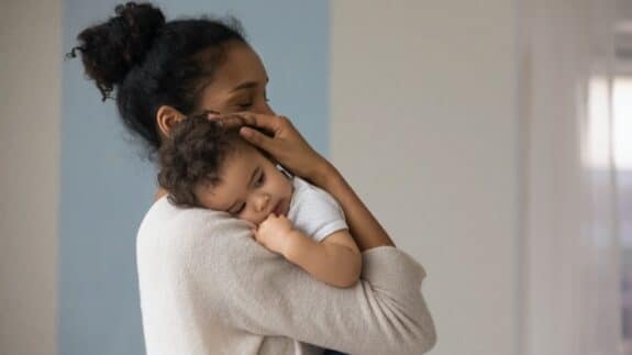 loving African American mom hug embrace small baby child