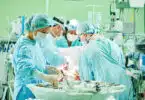 surgeons at work. female nurse at operation in child surgery hospital