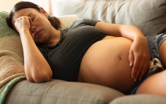 pregnant woman sick on the couch