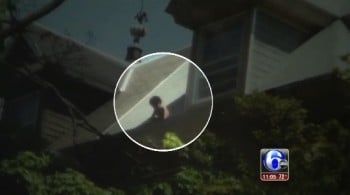 Toddler rescued from roof