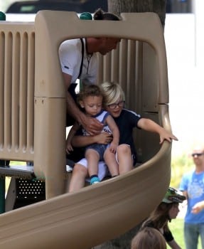Zuma Rossdale rides the slide with his brother Apollo