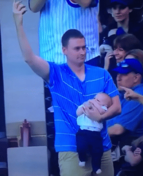 Dad catches ball while holding baby Cubs game
