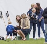 Prince George watches with The Duchess of Cambridge as Prince William plays polo with Prince Harry