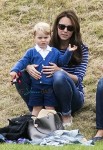 Prince George watches with The Duchess of Cambridge as Prince William plays polo with Prince Harry