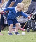 Prince George watches with The Duchess of Cambridge as Prince William plays polo with Prince Harry