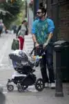 Sacha Baron Cohen takes his 4-month-old baby Montgomery Moses Brian for a stroll