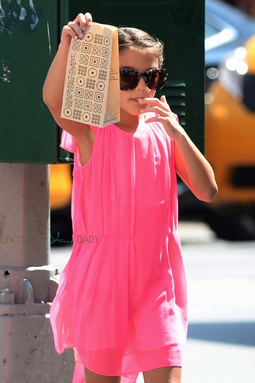 Suri Cruise snacks on donuts in NYC