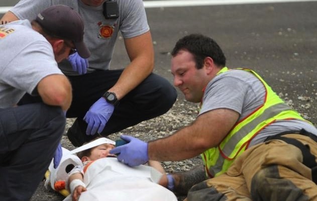 firefighter Casey Lessard shows a cartoon to a little boy