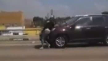 Motorists Film Video Of Pregnant Woman Clings to Car Driving on Freeway