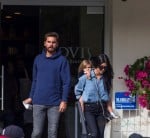 Penelope Disick gets a piggy back ride after a lunch at Lovi's with her mom Kourtney and dad Scott