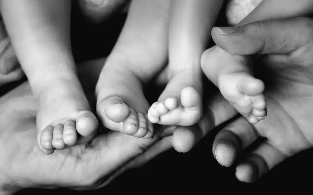 Baby Twins Feet in parents hands