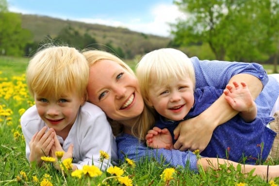 Happy Mother and Children Playing Outside