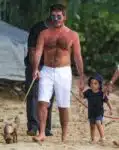 Simon Cowell and Lauren Silverman stroll on the beach with son Eric in Barbados