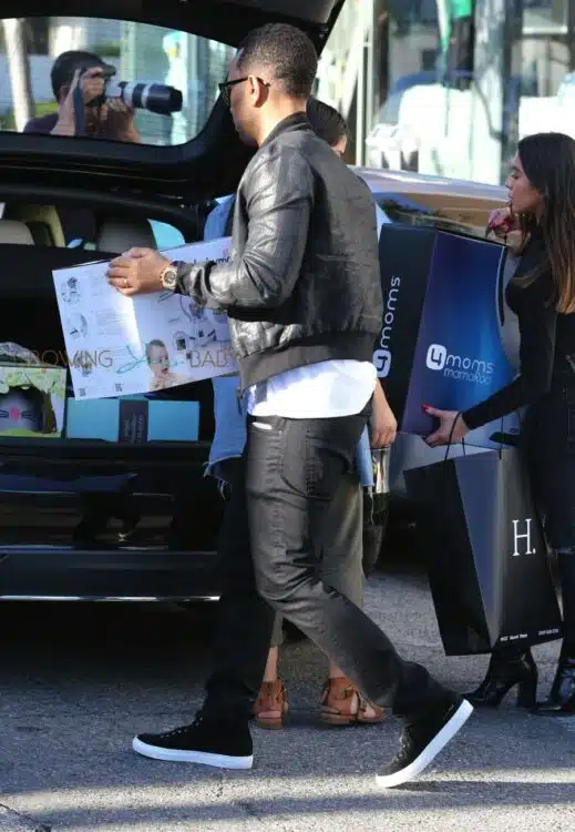 John Legend loads baby gear into the car after shopping with Kim and Kanye