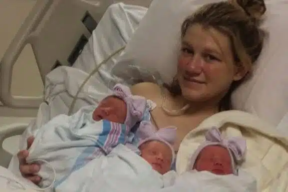 Amber Ertley  with her identical triplets