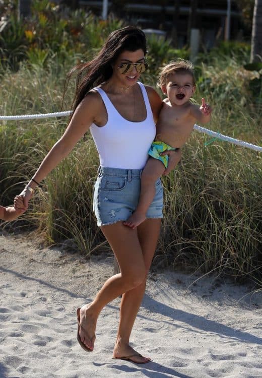 KOurtney Kardashian at the beach in Miami with son Reign Disick