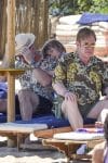 Elton John and David Furnish relax on the beach with their boys in Sardinia