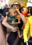 Kim Kardashian carries son Saint West at her grandmother's store opening in San Diego