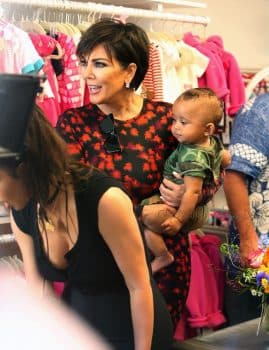 Kris Jenner carries grandson Saint West at her mother's store opening in San Diego