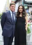 Robert Simonds and a pregnant Mila Kunis at Nasdaq