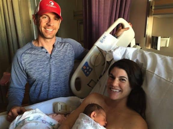 Sarah with her husband, Nick, and their newborn baby