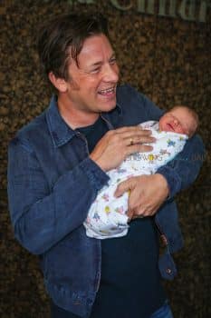 Jamie Oliver Craddles his baby boy outside the hospital