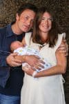 Jamie and Jules Oliver show off their baby boy outside the hospital