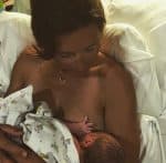 Jules Oliver breastfeeds her baby boy