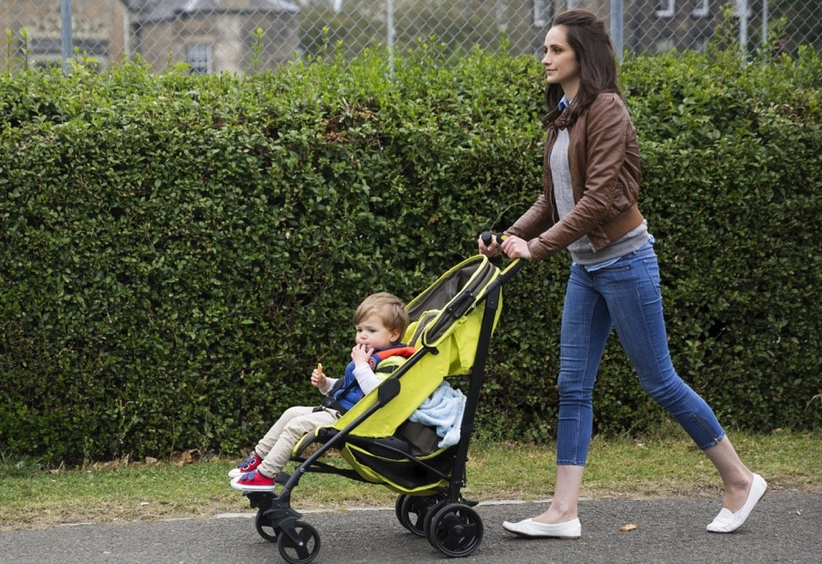 mom pushing child stroller