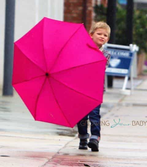 Samuel Affleck braves the rain to play hide and go seek with the photographers