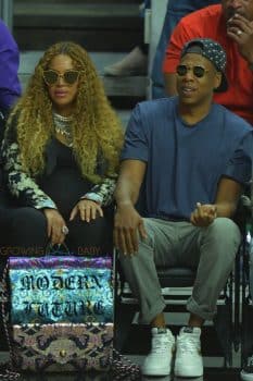 A very pregnant Beyonce and husband Jay Z sit courtside at the Clippers game