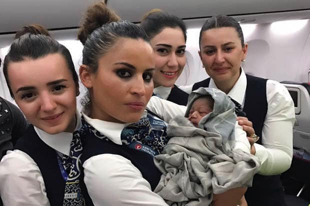 Airline crew help woman give BIRTH in mid air at 42,000ft